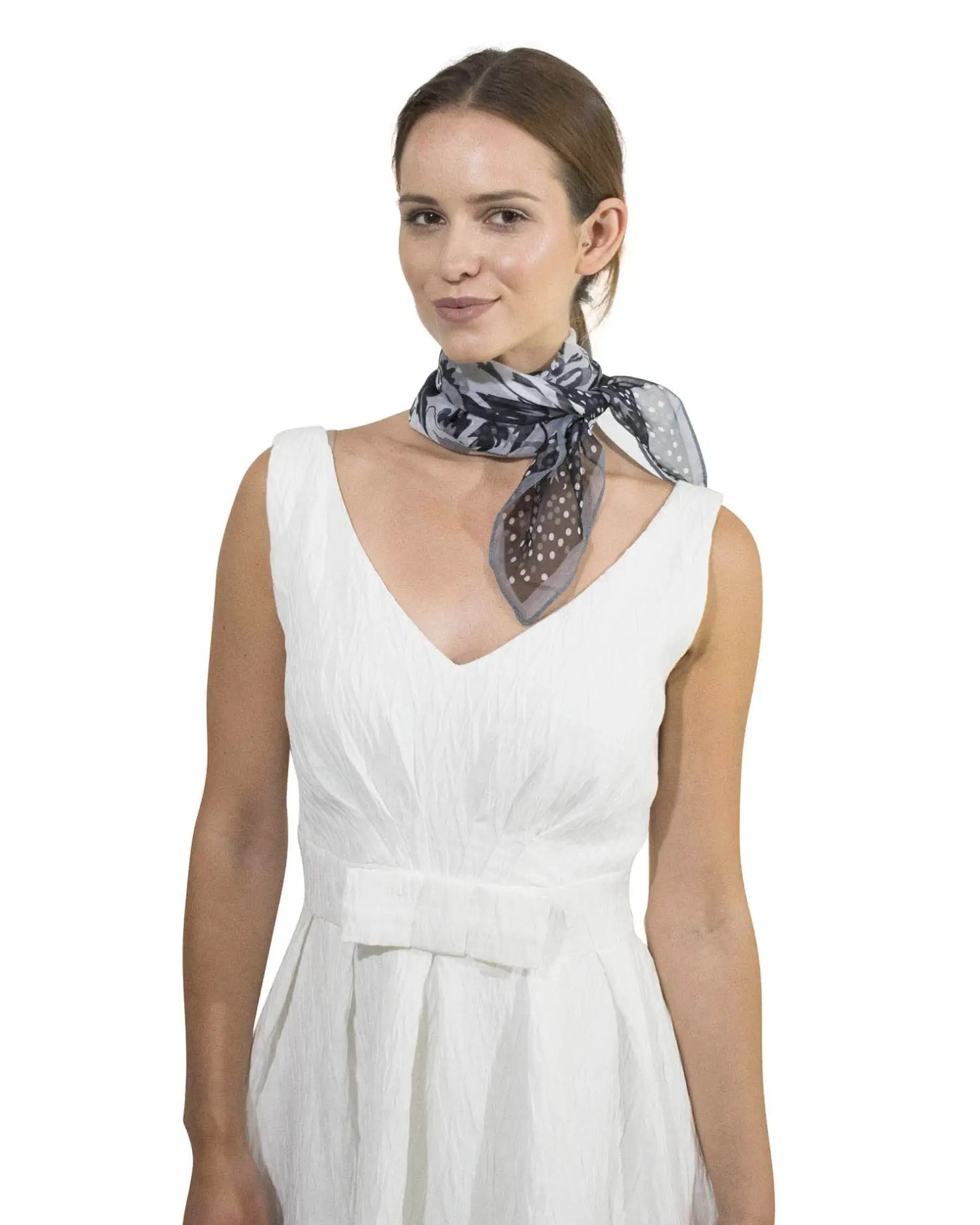 Woman in white dress and polka dot floral small square scarf