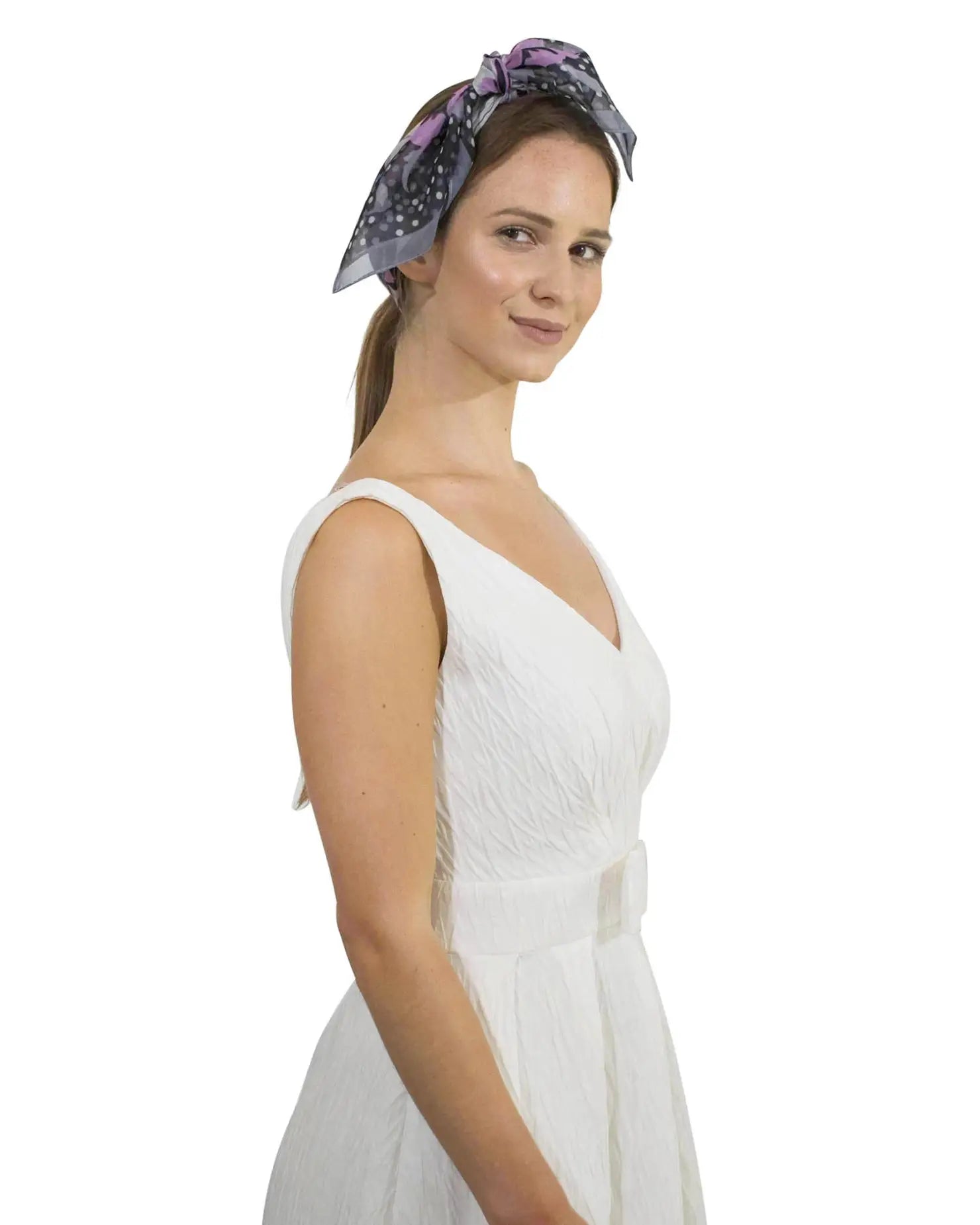 Woman wearing white dress and purple headband showcasing Charming Polka Dot & Floral Small Square Scarf.