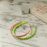 Pair of cherry print Alice headbands with green and pink hair ties