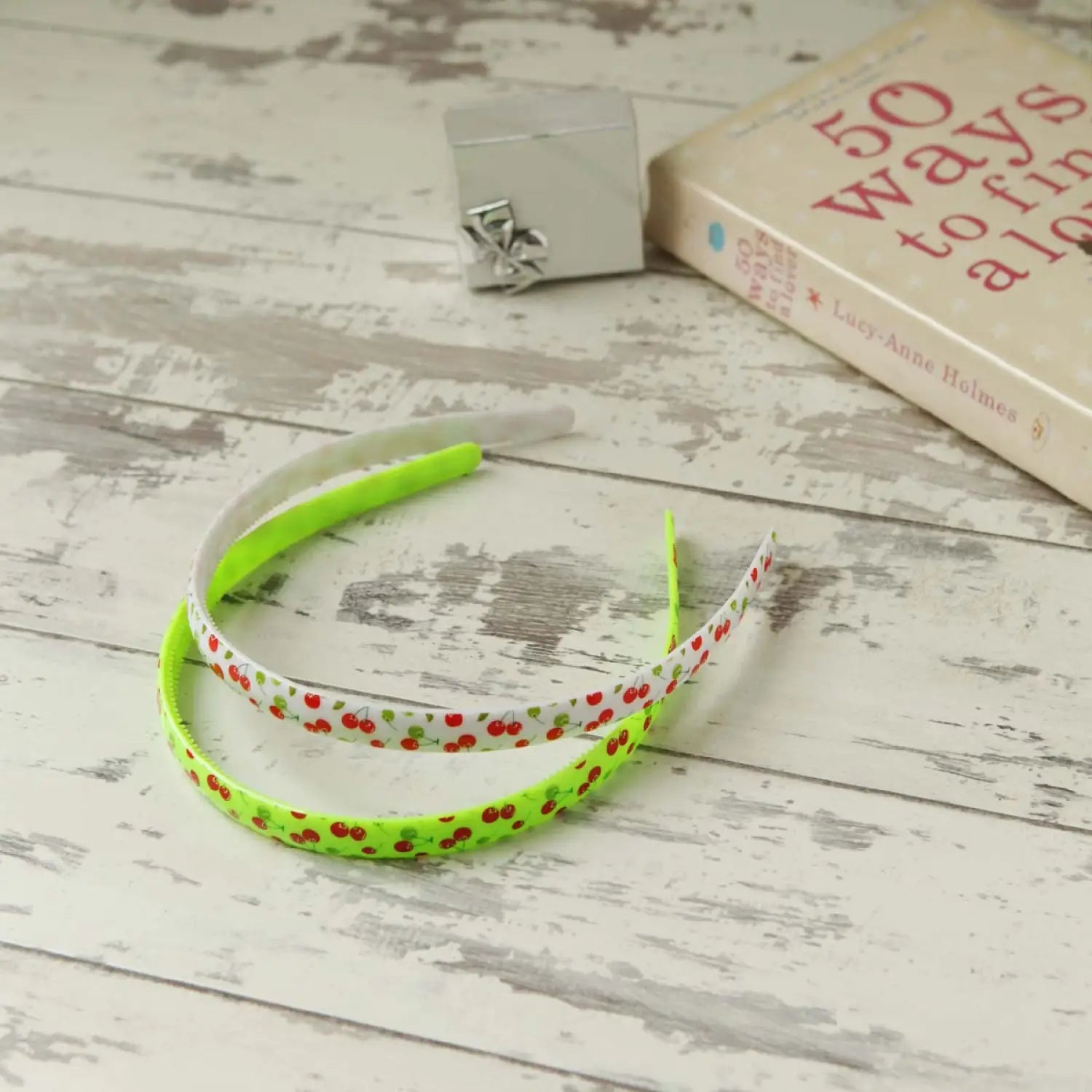 a green and white bracelet with red polka dots