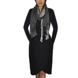 Woman wearing black dress and leopard print tasselled scarf by Chic Crinkled Stripes.