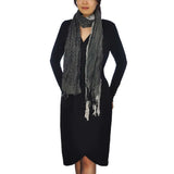 Stylish woman in black dress and chic crinkled stripes & leopard print tasselled scarf
