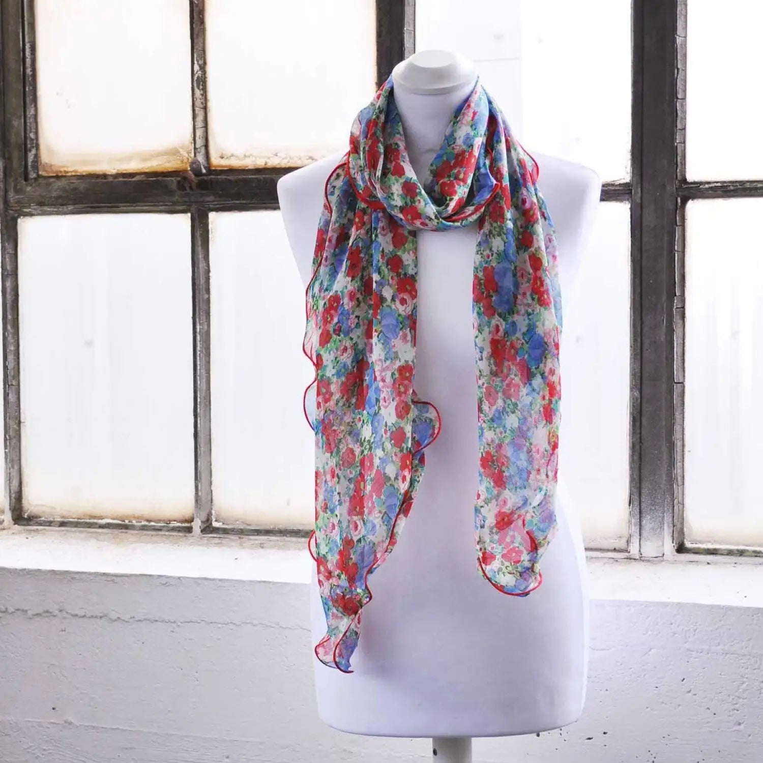 Chic Floral Print Waterfall-Edge Chiffon Scarf displayed on mannequin in front of window