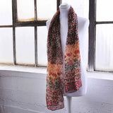 Chiffon floral print scarf displayed on mannequin in front of window