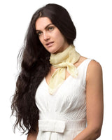 Woman wearing white dress and yellow chiffon square scarf from product named ’Chiffon Square Scarf - Lightweight, Square Neck Scarves for Women’.