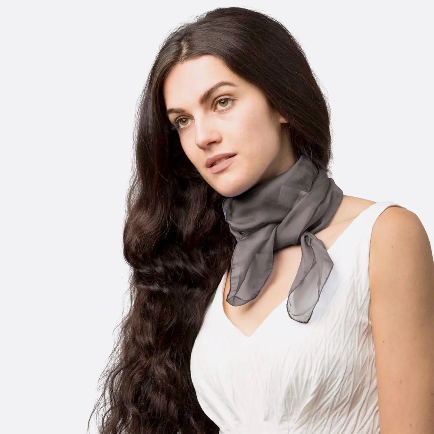 Woman wearing white dress and gray scarf, lightweight chiffon square scarf for women.