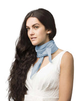 Woman wearing blue chiffon square scarf