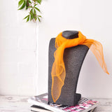 Chiffon square scarf in grey with orange scarf on top for retro organza fashion.
