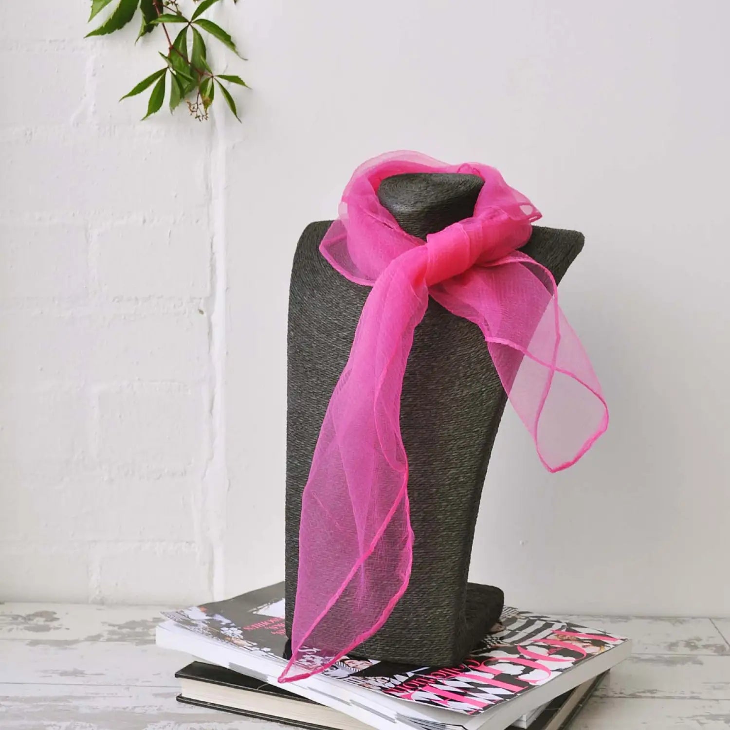 Pink chiffon square scarf tied to grey hat, stylish retro organza accessory