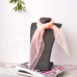 Black hat with pink bow on a chiffon square scarf for 60s & 70s style.