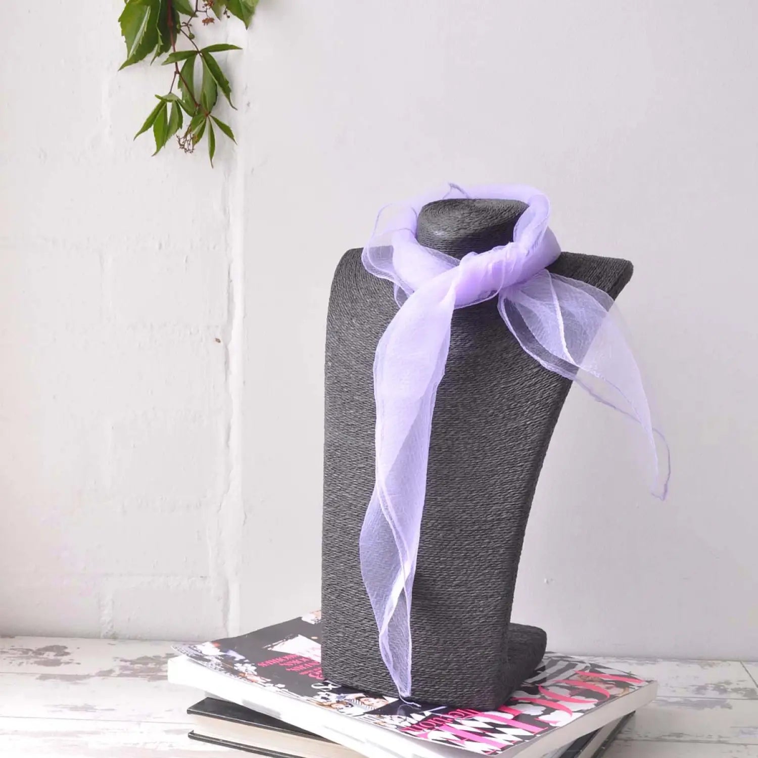 Chiffon square scarf with grey hat and purple ribbon displayed.
