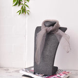Grey vase with bow on top featured in Chiffon Square Scarf Retro Organza for 60s & 70s Style.
