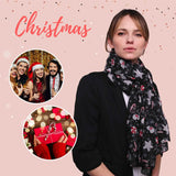 Woman with Christmas card and gift in oversized maxi shawl.