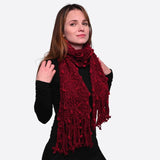 Woman wearing a red chunky bobble knit scarf for winter warmth.