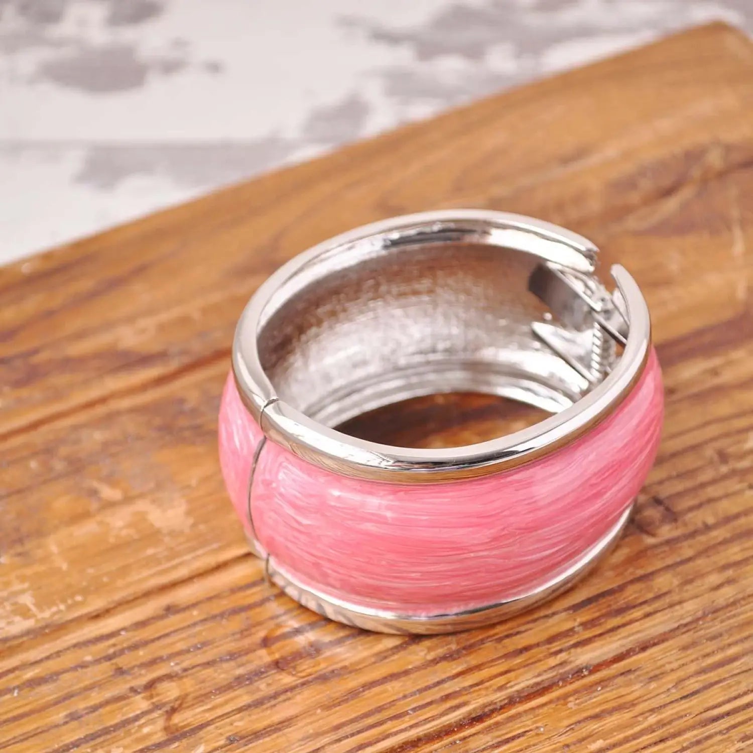 Chunky pastel hinged bangle on wooden board