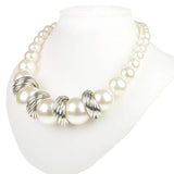 Chunky pearl necklace with silver swirl design