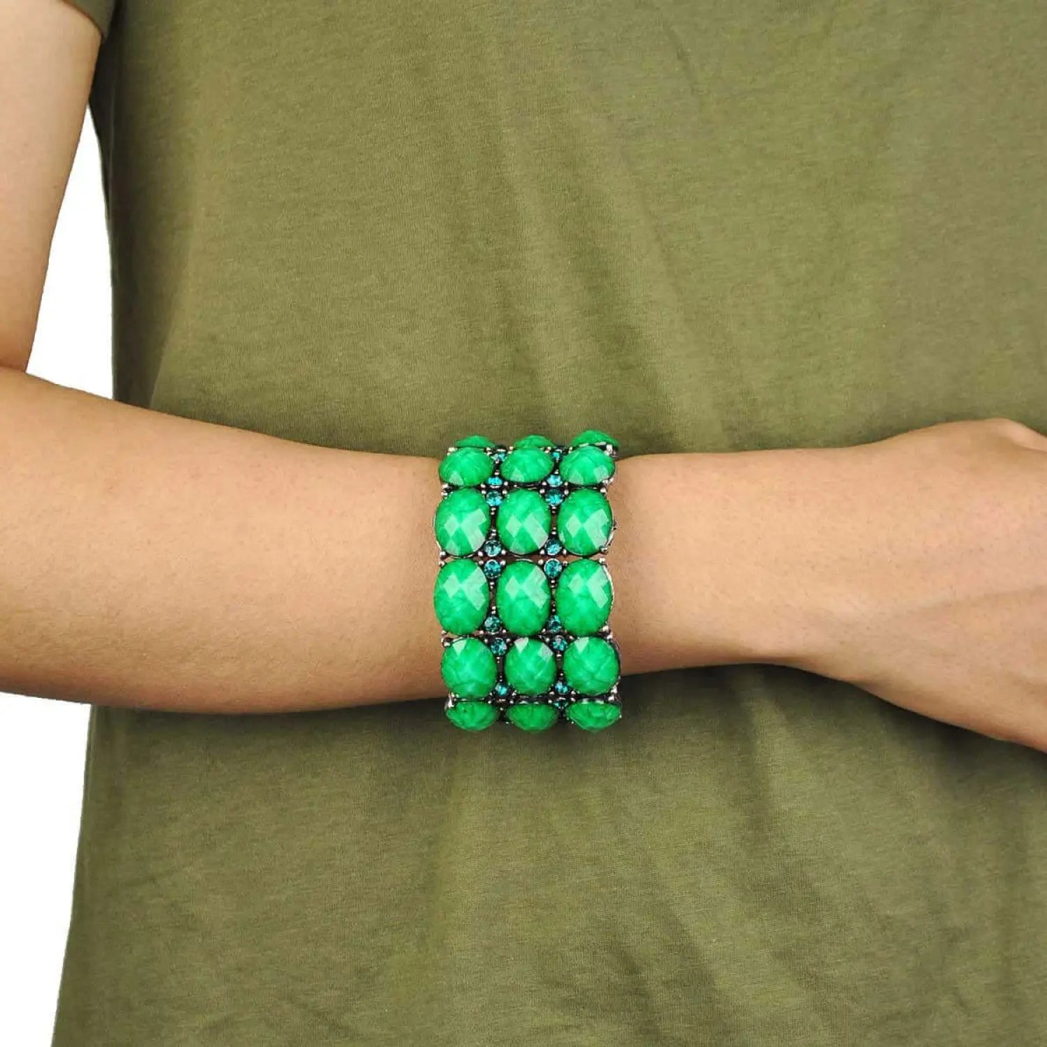 Green crystal statement bracelet with metal beads and chunky vivid metal design.