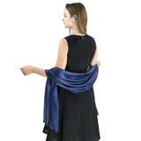 Elegant satin evening shawl, blue, draped over woman in black sleeveless dress