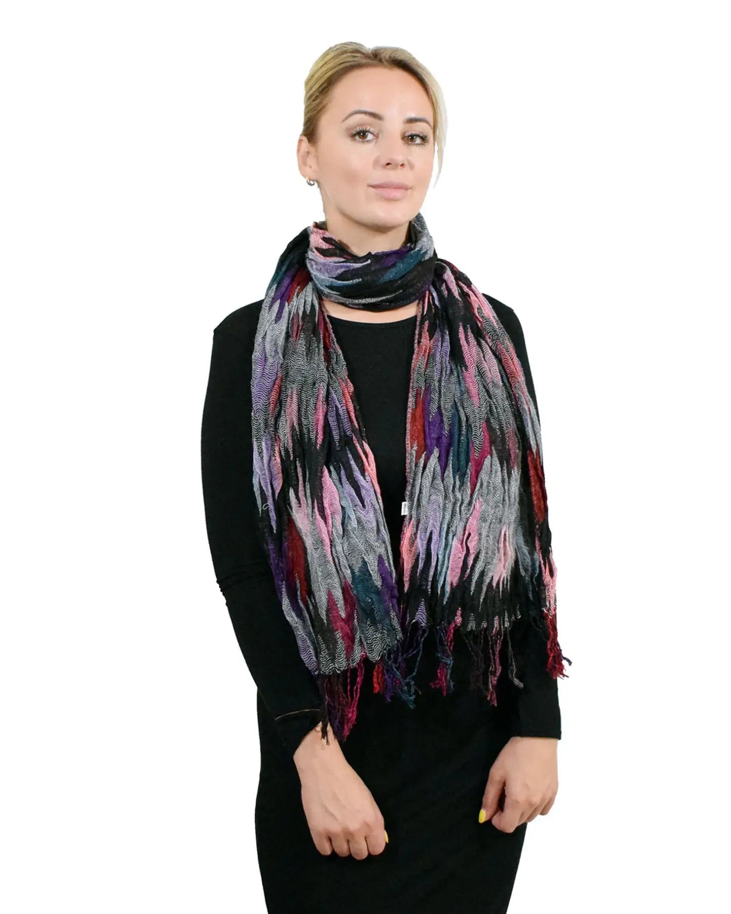 Woman wearing a black sweater and a colourful crinkled bobble knitted scarf