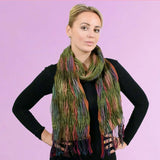 Woman wearing colourful crinkled bobble knitted scarf with colorful fringe.
