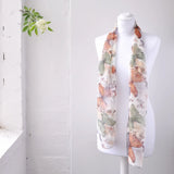 White mannequin displaying a floral print scarf from Colourful Large Butterfly Print Chiffon Scarf: Lightweight Elegance.