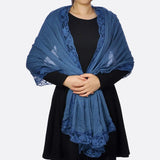 Woman wearing blue cotton crinkled lace-edged evening scarf.