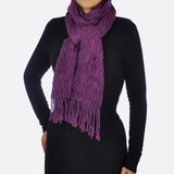 Crinkled cotton scarf with tassels in purple on a woman.