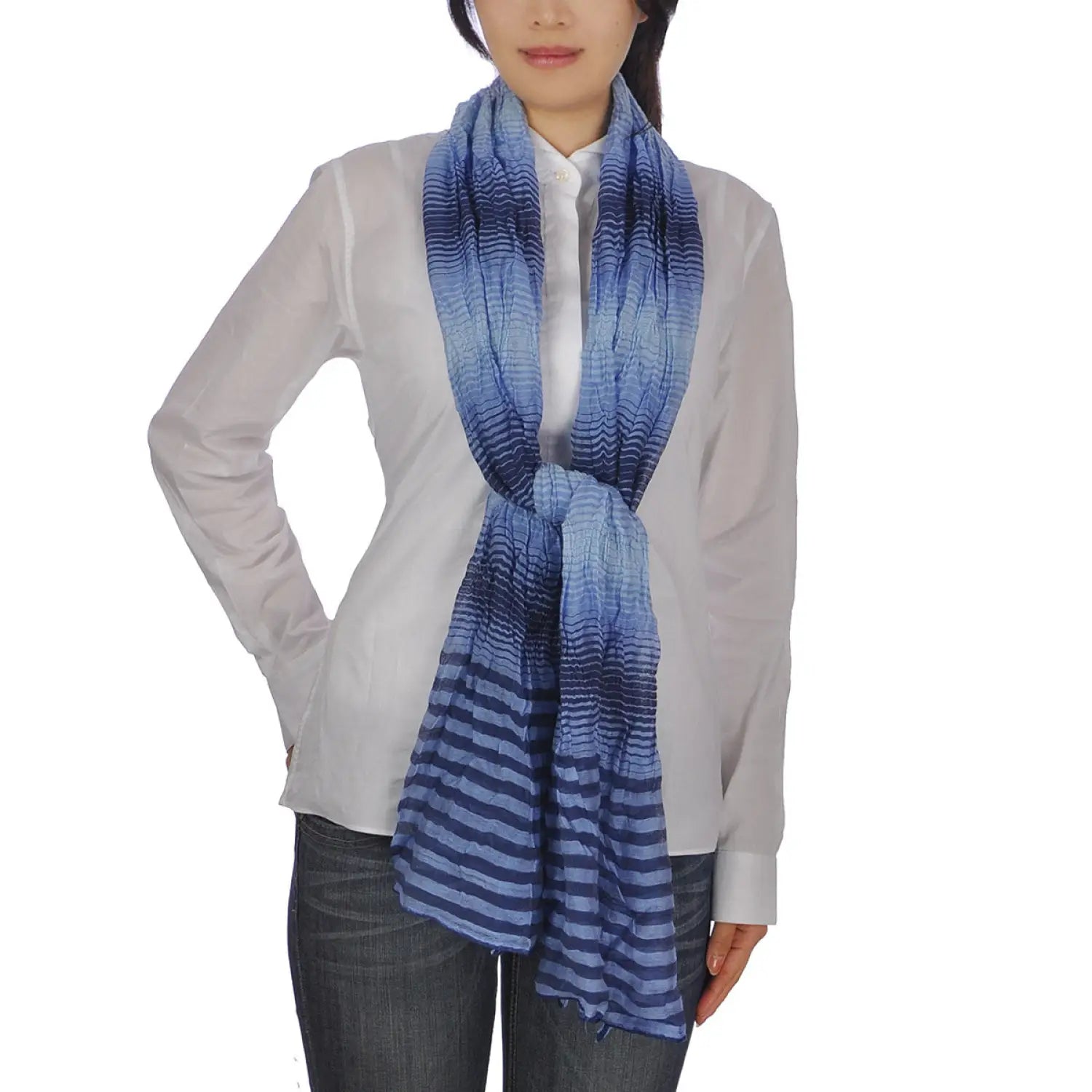 Woman wearing crinkled striped lightweight blue and white scarf