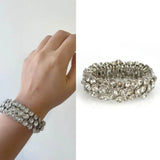 Close up of person’s hand holding Diamante Statement Silver Rhinestone Elasticated Bracelet.