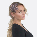 Woman wearing pink and black butterfly hair clip on Elegant Leaf Alice Headband.