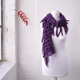 Elegant plain knitted purple scarf on mannequin