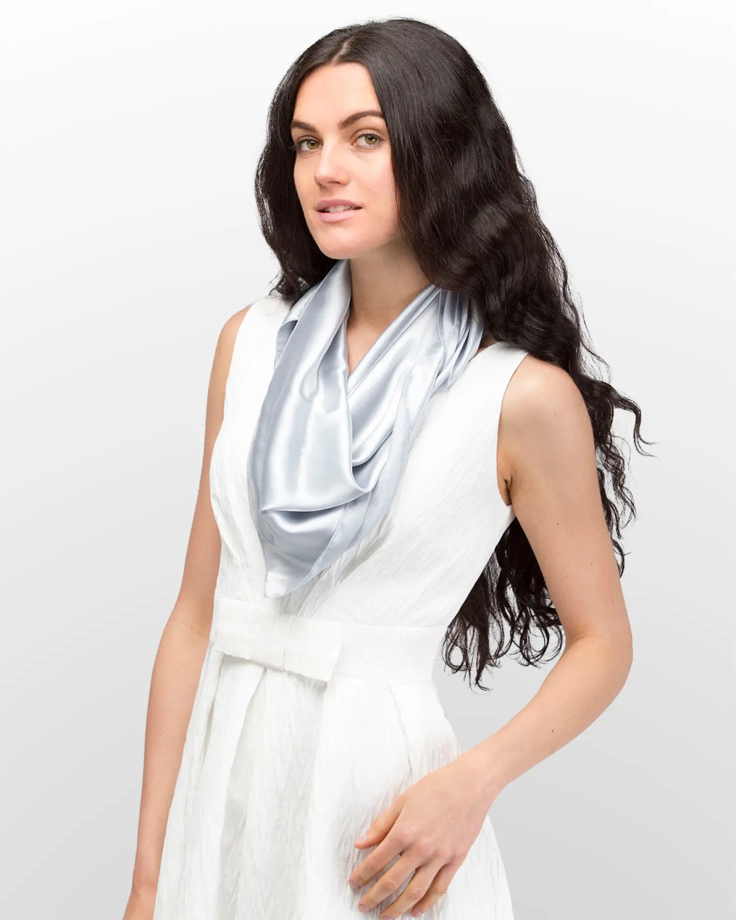 Woman in white dress and blue scarf showcasing Elegant Solid Satin Large Square Scarf.