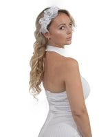 Woman in white dress with flower in hair wearing Elegant Stone & Pearl Lace Alice Headband.