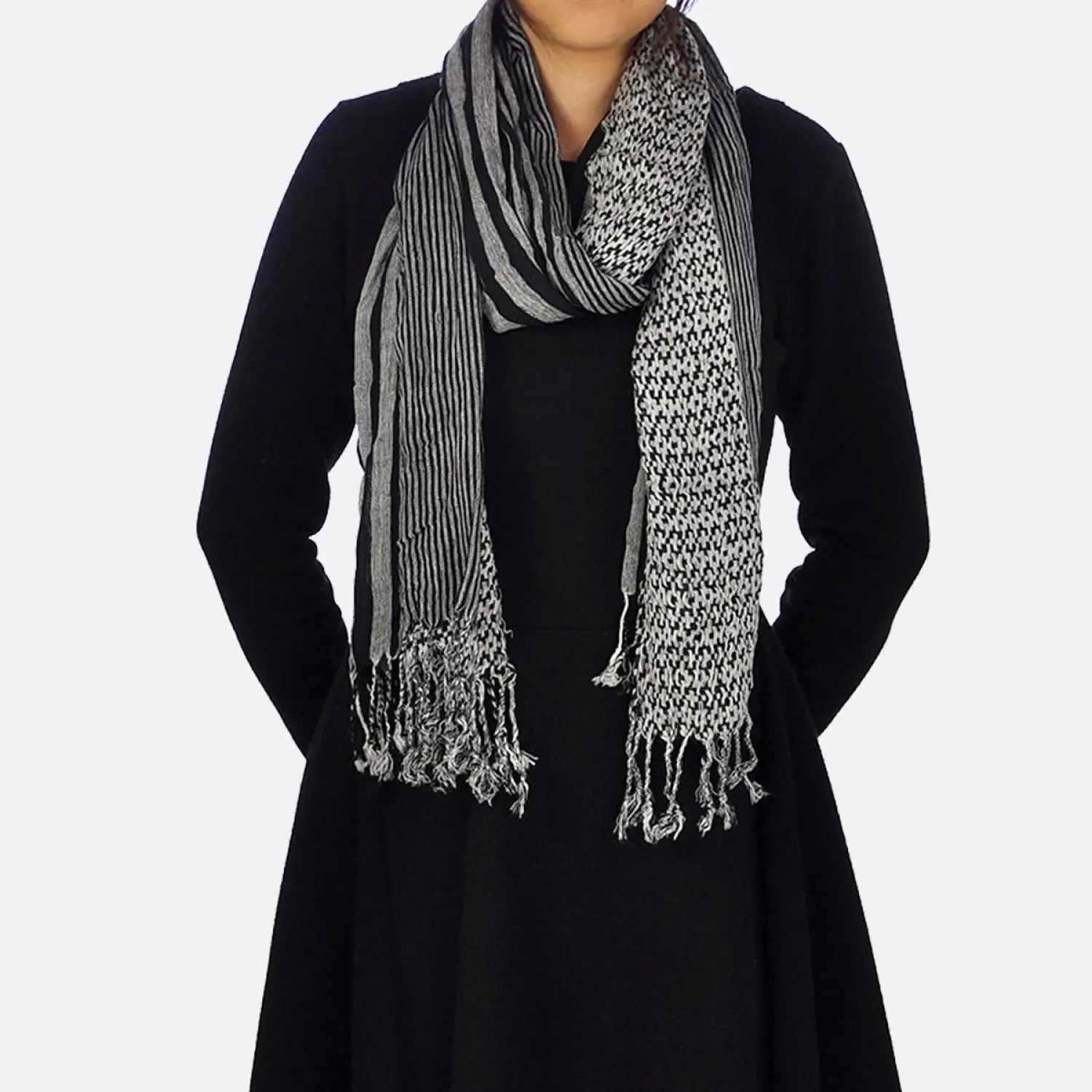 Elegant striped woven winter scarf on woman.