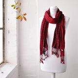 Red elegant striped woven winter scarf on mannequin