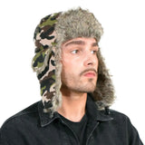 Stylish man in camouflage trapper hat with faux fur lining