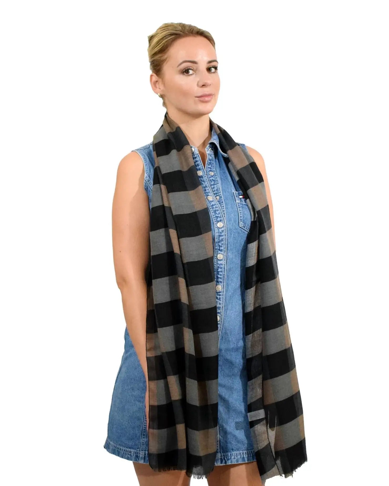 Woman wearing black and grey gingham check print oversized autumn scarf.