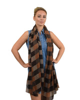 Woman wearing a brown and black gingham check print scarf