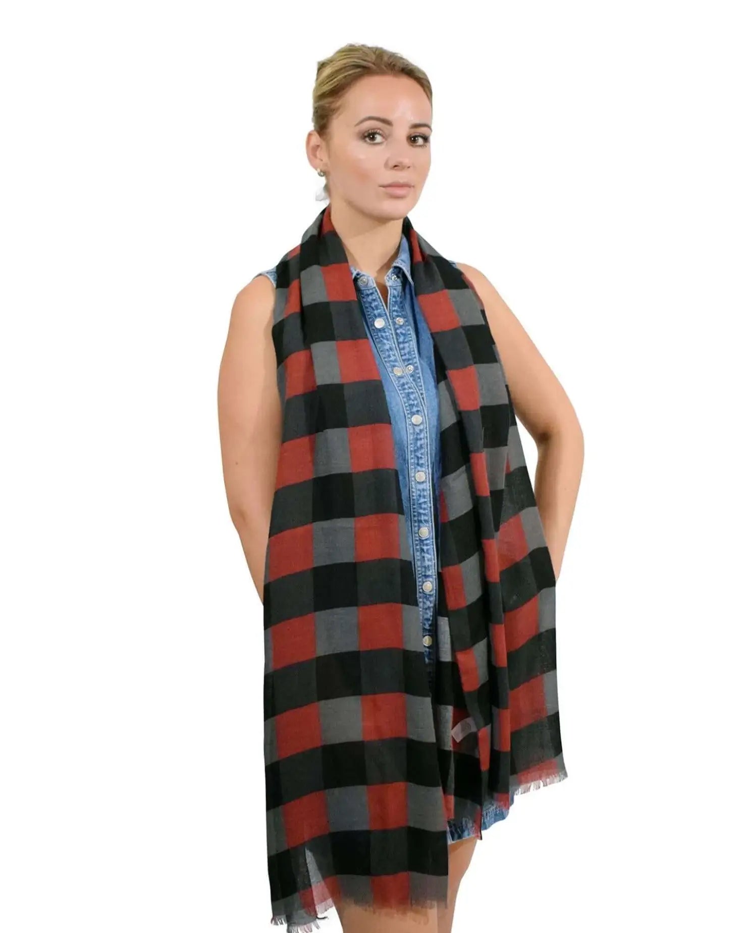 Woman wearing a red and black gingham check print oversized autumn scarf.