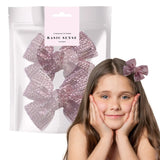 Girl with long hair wearing pink bow in Glamorous Rhinestone Ribbon Alligator Hair Clips - 2 Pack.
