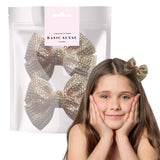 Girl with long brown hair wearing gold bow in Glamorous Rhinestone Ribbon Alligator Hair Clips - 2 Pack