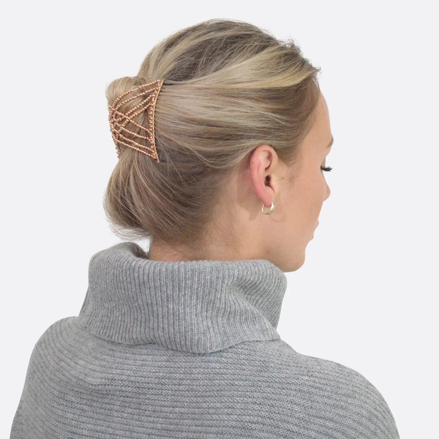 Woman wearing grey sweater with gold hair clip, showcasing Glossy Beaded Design Hair Accessory Magic Comb.