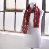 Red chiffon scarf with gold foil music instrument design