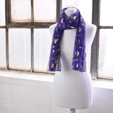 Purple chiffon scarf with gold foil music instrument design.