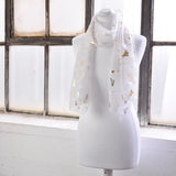 White chiffon scarf with gold foil music instrument design.