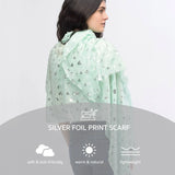 Green scarf with cow print and silver foil oversized scarf by Heart featured on white background.