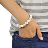 Woman wearing howlite turquoise stone bracelet with white pearls and silver beads