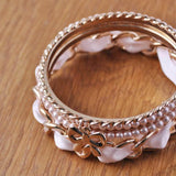Gold plated bangle with imitation pearls and peach ribbon.