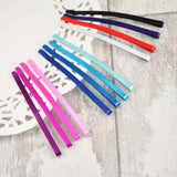 Rainbow colored hair clip on white background from Jumbo Metal Bobby Pins product.