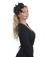 Stylish woman wearing black dress and large bow flower headband with rhinestone applique